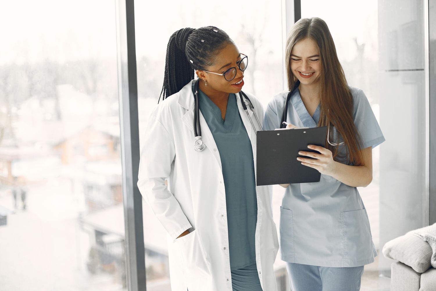 A provider and a nurse reviewing a chart together, smiling